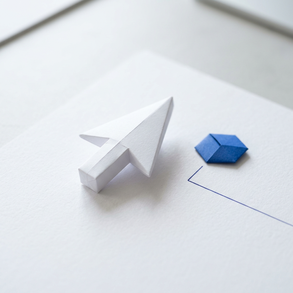 A white folded-paper cursor arrow and a small blue paper shape resting on a white sheet.